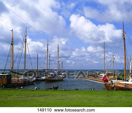 Boats at harbor under cloudy sky, Mecklenburg-Vorpommern, Germany View Large Photo Image Stock Image - Boats at harbor under cloudy sky, Mecklenburg-Vorpommern, Germany . Fotosearch