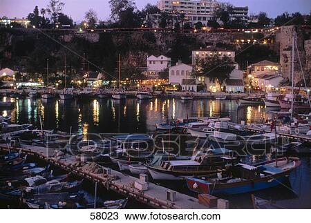 Stock Image - Boats in harbor at dusk, Antalya, Turkey . Fotosearch