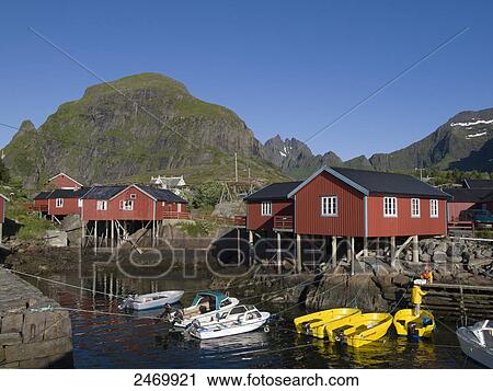 Stock Image - Boats moored near stilt houses, Moskenesoya, Lofoten, Nordland County, Norway . Fotosearch