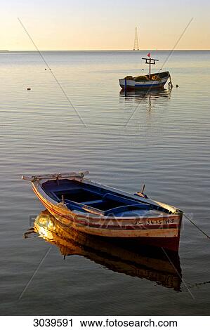 Stock Image - Boats on water at dawn, Ajim, Djerba, Tunisia . Fotosearch