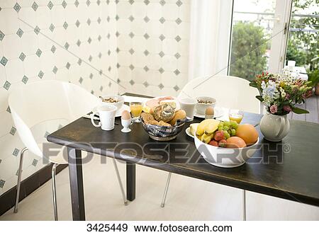 Stock Photo - Breakfast on a wooden table, elevated view . Fotosearch