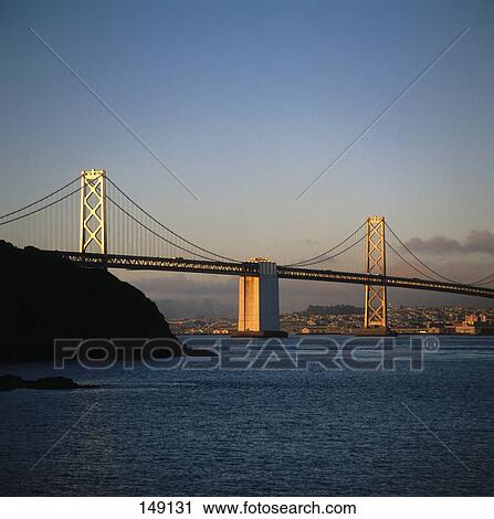 Stock Image - Bridge across river at dusk, Bay Bridge, San Francisco, California, USA . Fotosearch
