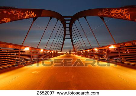 Stock Photo - Bridge lit up at dusk, Prenzlauer Berg, Berlin, Germany . Fotosearch