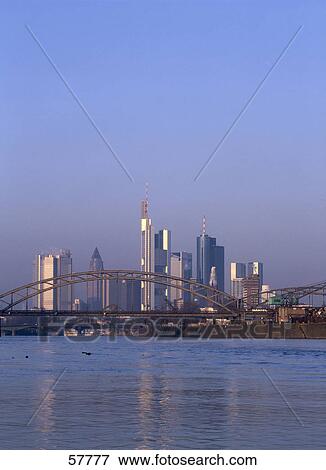 Stock Photo - Bridge with city skyline in background, Frankfurt, Hessen, Germany . Fotosearch