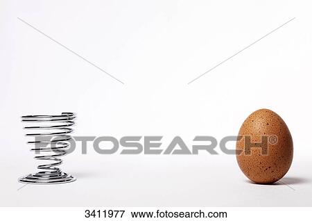Brown egg and egg cup View Large Photo Image Stock Photo - Brown egg and egg cup . Fotosearch