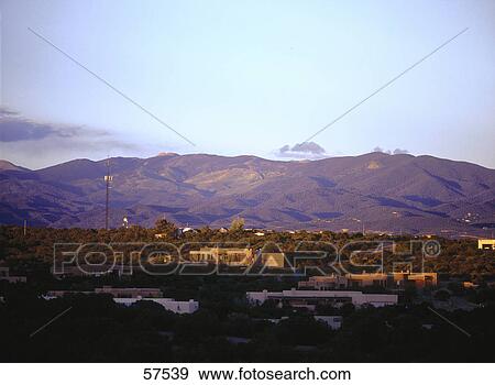 Stock Photo - Buildings on a landscape with mountains in the background, Santa Fe, New Mexico, USA . Fotosearch