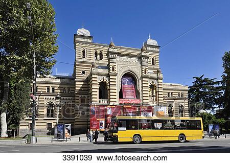 Stock Photo - Bus in front of a theatre building in Tbilisi, Georgia . Fotosearch