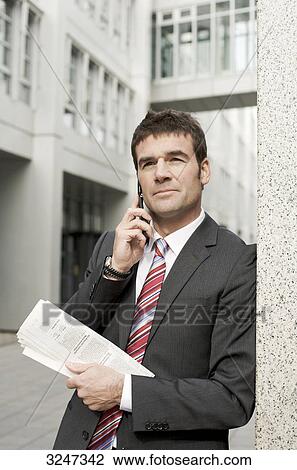 Businessman using mobile phone, waist up View Large Photo Image Stock Image - Businessman using mobile phone, waist up . Fotosearch