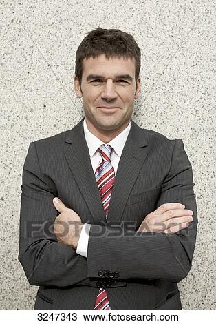 Businessman with crossed arms, waist up View Large Photo Image Stock Image - Businessman with crossed arms, waist up . Fotosearch