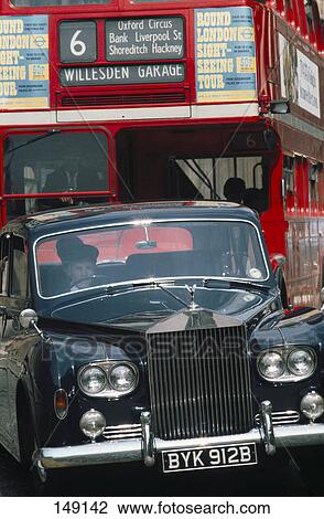 Stock Image - Car and double-decker bus on road, London, England . Fotosearch
