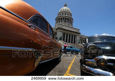 Stock Photo - Cars in front of government building, El Capitolio, Havana, Cuba . Fotosearch