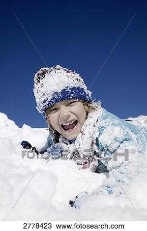 Stock Image - child playing in snow . Fotosearch