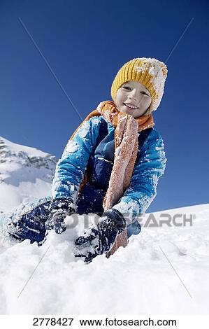 Stock Photo - child playing in snow . Fotosearch