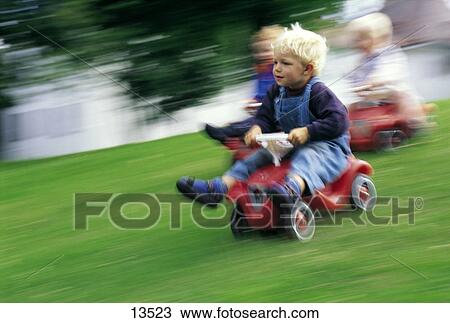 Children on toy cars, blurred View Large Photo Image Stock Image - Children on toy cars, blurred . Fotosearch