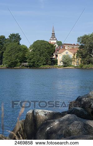 Church and houses at waterfront, Lake Vaettern, Hjo, Vaestra Goetaland County, Sweden View Large Photo Image Stock Photo - Church and houses at waterfront, Lake Vaettern, Hjo, Vaestra Goetaland County, Sweden . Fotosearch