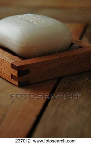 Stock Image - Close-up of bar of soap in soap dish . Fotosearch