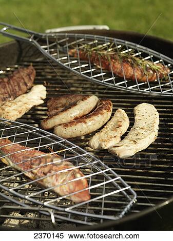 Close-up of fish and sausages on barbecue grill View Large Photo Image Stock Photography - Close-up of fish and sausages on barbecue grill . Fotosearch