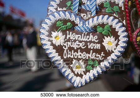 Stock Image - Close-up of heart shape of gingerbread in fairground, Oktoberfest, Munich, Bavaria, Germany . Fotosearch