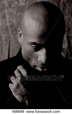Close-up of mid adult man thinking View Large Photo Image Stock Photo - Close-up of mid adult man thinking . Fotosearch