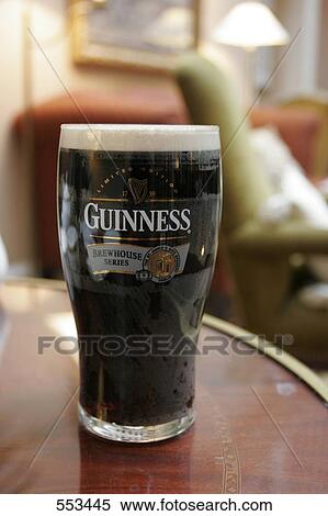 Stock Photography - Close-up of pint of Guinness on table . Fotosearch
