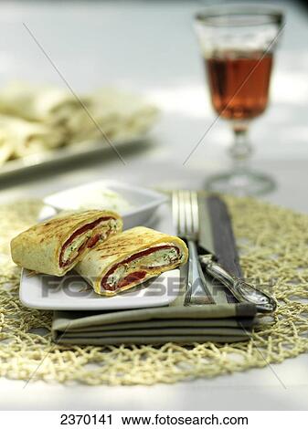 Stock Image - Close-up of slices of sprig roll on plate . Fotosearch