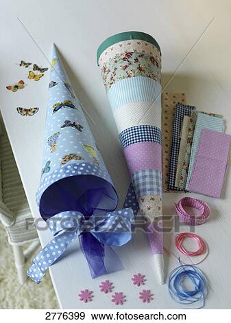 Stock Photo - Close-up of two cardboard cones and ribbons on table . Fotosearch