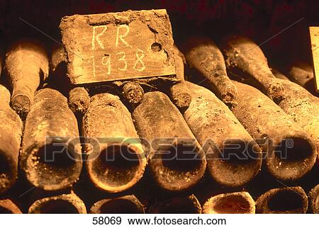 Stock Photo - Close-up of wine bottles in dusty cellar . Fotosearch