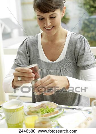 Close-up of woman having breakfast and smiling at table View Large Photo Image Stock Image - Close-up of woman having breakfast and smiling at table . Fotosearch