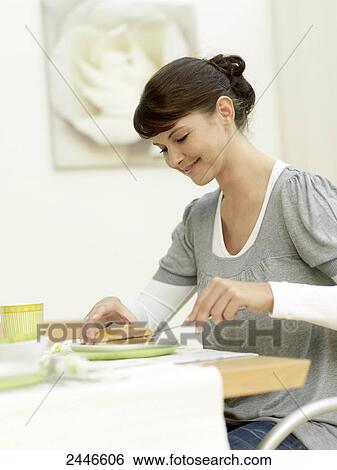 Stock Photograph - Close-up of woman having breakfast at table . Fotosearch