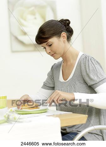 Stock Photography - Close-up of woman having breakfast at table . Fotosearch