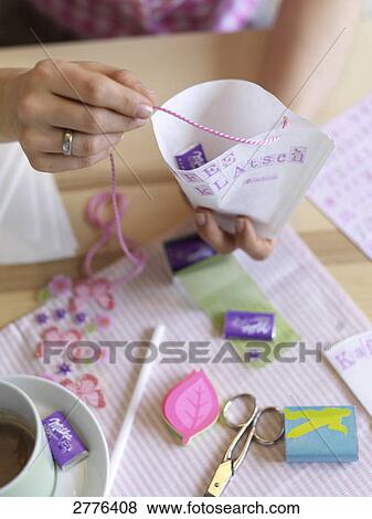 Stock Photo - Close-up of woman making invitation card at table . Fotosearch