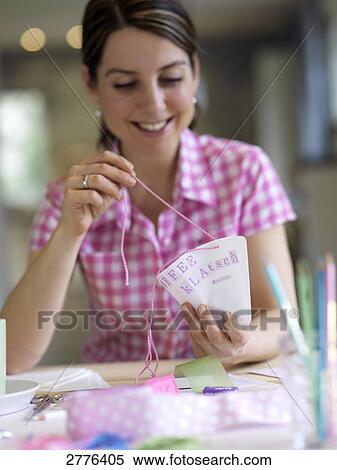 Close-up of woman making invitation card at table and smiling View Large Photo Image Stock Photography - Close-up of woman making invitation card at table and smiling . Fotosearch