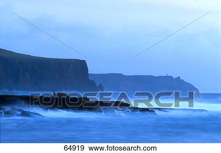 Stock Photo - Coastal cliffs at dusk, Doolin, County Clare, Republic Of Ireland . Fotosearch