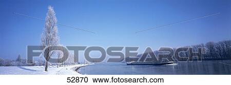 Container ship in river with snow covered trees at riverside, Rhine River, Germany View Large Photo Image Stock Image - Container ship in river with snow covered trees at riverside, Rhine River, Germany . Fotosearch