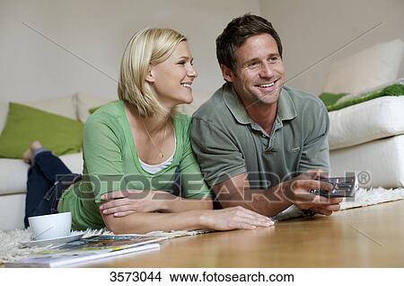 Picture - Couple at home watching TV . Fotosearch