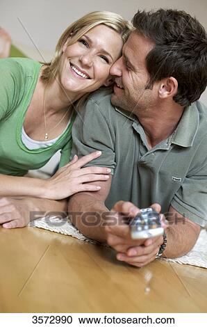 Couple at home watching TV View Large Photo Image Stock Image - Couple at home watching TV . Fotosearch