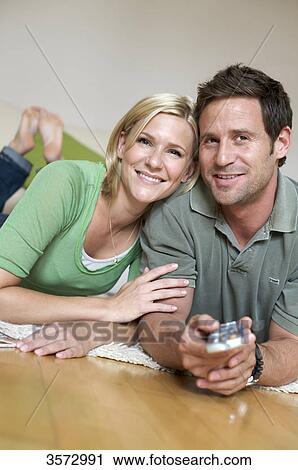 Couple at home watching TV View Large Photo Image Stock Image - Couple at home watching TV . Fotosearch