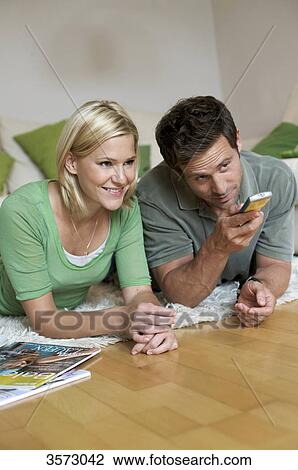 Couple at home watching TV View Large Photo Image Stock Image - Couple at home watching TV . Fotosearch