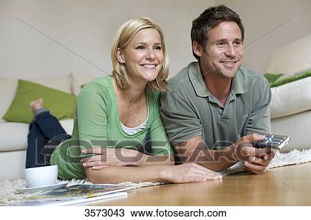 Couple at home watching TV View Large Photo Image Stock Image - Couple at home watching TV . Fotosearch