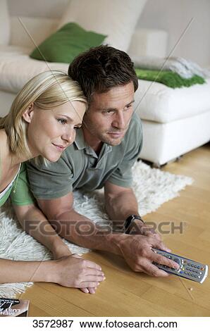 Stock Photo - Couple at home watching TV . Fotosearch