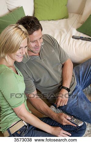 Couple at home watching TV View Large Photo Image Stock Photo - Couple at home watching TV . Fotosearch