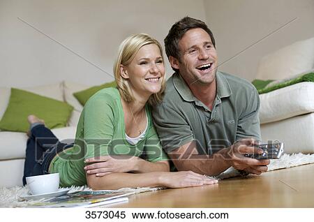 Couple at home watching TV View Large Photo Image Stock Photography - Couple at home watching TV . Fotosearch