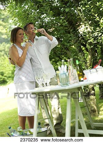 Couple drinking wine in garden View Large Photo Image Stock Photography - Couple drinking wine in garden . Fotosearch
