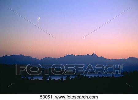 Crescent moon above a mountain range View Large Photo Image Stock Image - Crescent moon above a mountain range . Fotosearch
