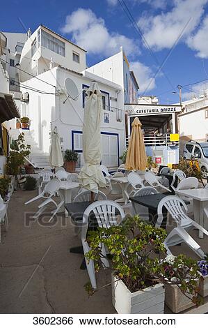 Empty outdoor restaurant in Burgau, Algarve, Portugal View Large Photo Image Stock Photograph - Empty outdoor restaurant in Burgau, Algarve, Portugal . Fotosearch