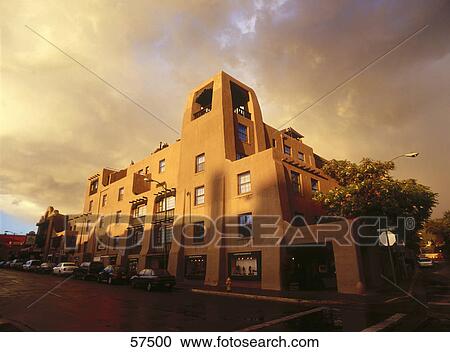 Stock Image - Evening sunlight falling on hotel building, La Fonda Hotel, Santa Fe, New Mexico, USA . Fotosearch