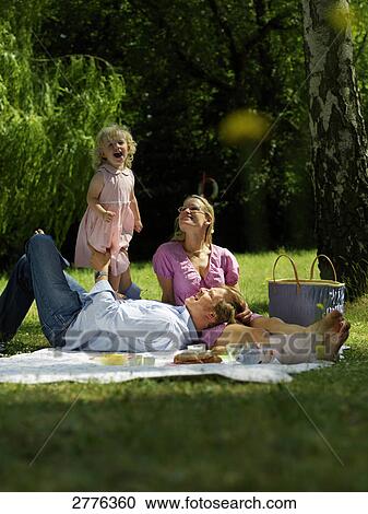 Family enjoying at picnic View Large Photo Image Stock Image - Family enjoying at picnic . Fotosearch