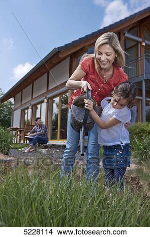 Picture - Family in front of Lehner energy house, Poing, Bavaria, Germany, Europe . Fotosearch