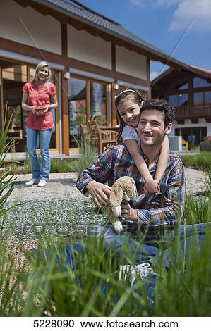 Stock Image - Family in front of Lehner energy house, Poing, Bavaria, Germany, Europe . Fotosearch