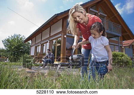 Family in front of Lehner energy house, Poing, Bavaria, Germany, Europe View Large Photo Image Stock Image - Family in front of Lehner energy house, Poing, Bavaria, Germany, Europe . Fotosearch